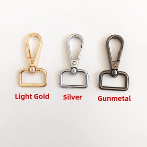 Detailed view of metal lobster clasps in light gold, silver and gunmetal finishes