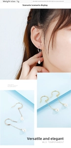 Detail of lightweight pearl drop earrings featuring metal hooks and teardrop pearls