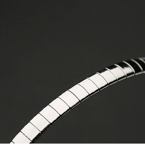 Close-up of a minimalist silver metallic elastic bracelet with polished square links