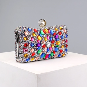 Close-up of colorful rhinestones on evening clutch bag with silver metal frame