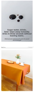 Macro view of orange waterproof faux leather tablecloth showing liquid resistance detail