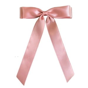Detail of elegant pink satin double bow hairclip with long flowing silk ribbons