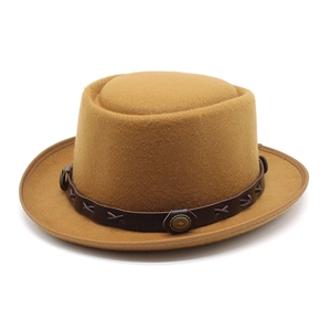 Detail of camel wool pork pie hat with brown leather band and metallic studs