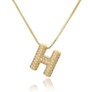 Gold letter H pendant necklace with micro-paved cubic zirconia on a white background