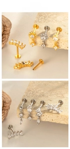 Detailed view of titanium flat back piercings with star and leaf crystal designs