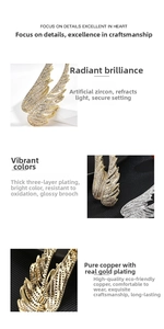 Detailed macro view of gold-plated copper wing brooch featuring full cubic zirconia stones