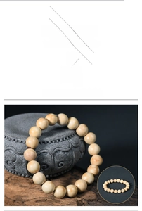 Detailed texture of light wood beads on vintage stone base for meditation