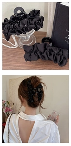 Détail de la grande pince à cheveux en satin plissé noir avec pois blancs pour femmes