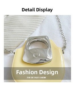 Detailed shot of yellow mini bag featuring silver square handle and metallic chain strap