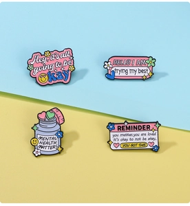 Detailed view of enamel mental health awareness pins on a split color background