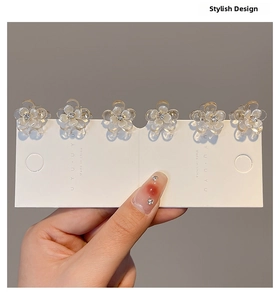 Set of six mini camellia flower hair clips with rhinestones held on display card