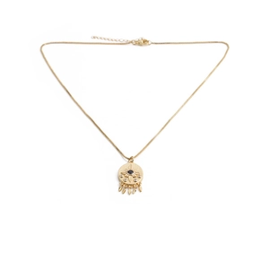 Golden sunburst evil eye necklace with black gemstone and delicate fringe charms