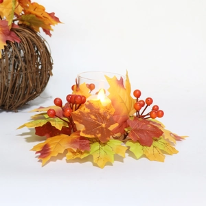 Detail of harvest candle holder with silk maple leaves, berries, and LED glass candle