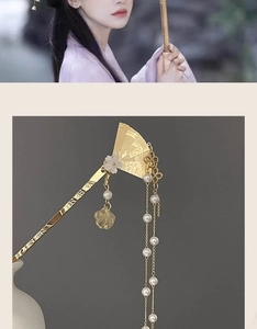 Macro detail of Chinese golden fan hair pin with white pearl tassels and flower charm