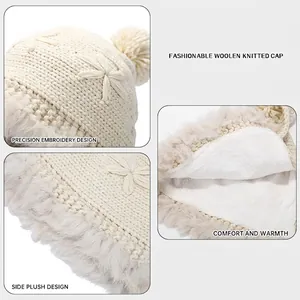 Handmade knitted hat with pom-pom and warm fleece lining for cold weather protection