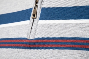 Detail of knit sweater showing colorful stripes and a premium bronze metal half-zipper
