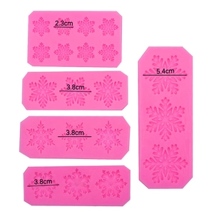 Pink silicone snowflake mold set for baking and resin craft with various size markings