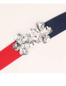 Detail of red and blue elastic belt featuring elegant silver metal flower buckles