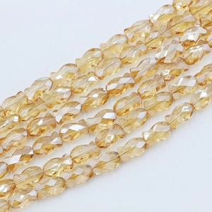 Macro shot of multi-strand champagne faceted fish-shaped glass beads for jewelry making