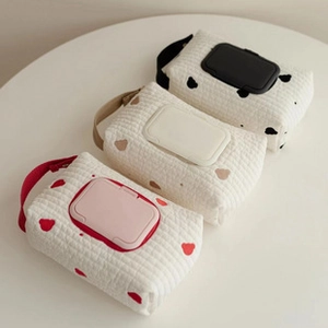 Three quilted cotton baby wipes pouches in cow and bear prints with flip lids
