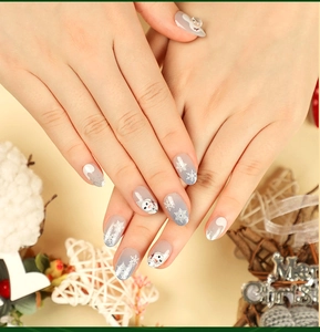 Detail of Christmas press-on nails featuring gray gradient with snowflake and snowman art