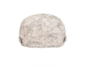 Detail view of the back of a vintage washed denim flat cap with adjustable metal buckle strap