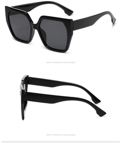 Detail view of stylish black oversized square sunglasses with a glossy resin frame finish