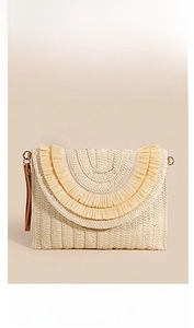 Detail of beige straw envelope clutch bag with multi-layer raffia fringe and leather wristlet