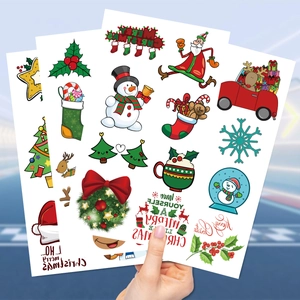 Detailed close-up of colorful waterproof Christmas temporary tattoos for kids party