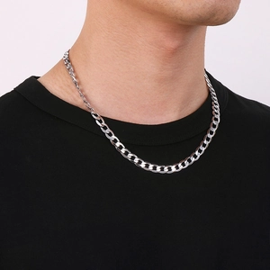 Close-up of a 7mm silver stainless steel NK Cuban chain necklace on male model neck