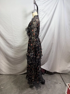 Detail of tiered chiffon maxi dress featuring black paisley print and ruffled sleeves