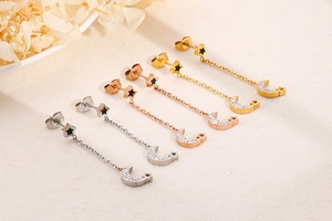Detailed view of moon and star tassel earrings in gold, rose gold, and silver finishes