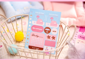 Detail of November theme blue stationery stickers in a basket with soft decor
