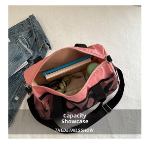 Top view of pink nylon travel bag showing large interior storage space for daily items