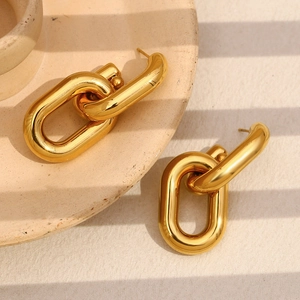 18K gold plated hollow chain link earrings in minimalist style on ceramic plate
