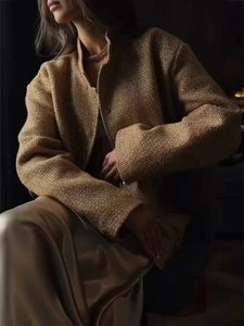 Close-up of sequined tweed texture on a golden vintage style jacket for women