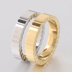 Close-up of gold and silver stainless steel rings with geometric ice cube pattern