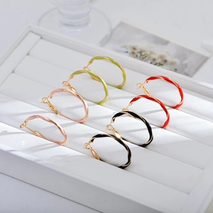 Chic twisted gold hoop earrings with colorful enamel glaze in multiple vibrant colors
