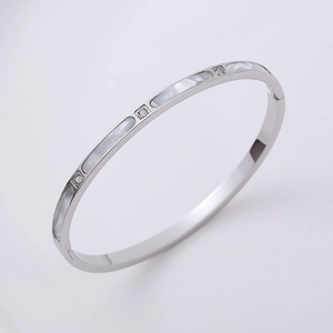 Close-up of silver bangle with mother of pearl inlay and square-cut crystal settings