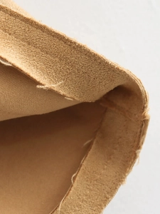 Macro detail showing high-quality tan suede lining and durable stitching on the jacket