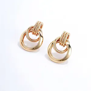 Fashionable gold interlocking triple hoop earrings with a polished metallic finish
