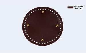 Detail of 15cm round dark brown leather bag base with pre-punched holes and gold studs