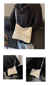 Detail of cream woven crossbody bag with geometric hollow patterns and tassels