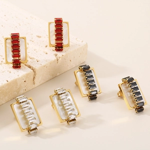 Detail showing rectangular gold stud earrings with zircon and colorful shell textures