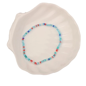 Handmade colorful seed bead bracelet with bohemian patterns on a shell-shaped tray
