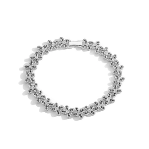 Close-up of silver clover bracelet featuring polished black stone inlays and clasp
