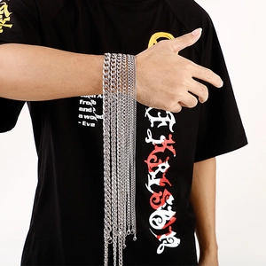 Detail of silver stainless steel Cuban link chains in various widths on male wrist
