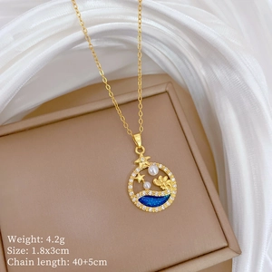 Detail of gold pendant with star, pearl, and blue enamel wave on beige jewelry box
