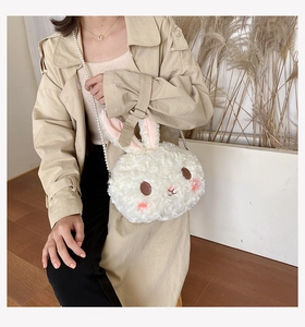 Detailed close-up of white plush bunny bag with soft fur texture and elegant pearl chain