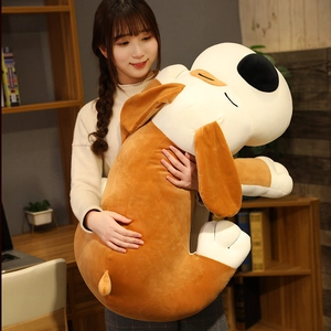 Close-up of huge plush dog pillow held by a girl in a cozy home library setting